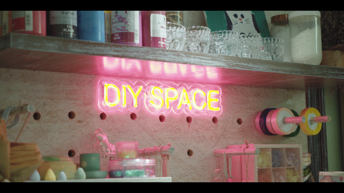 a pink neon sign that says diy space