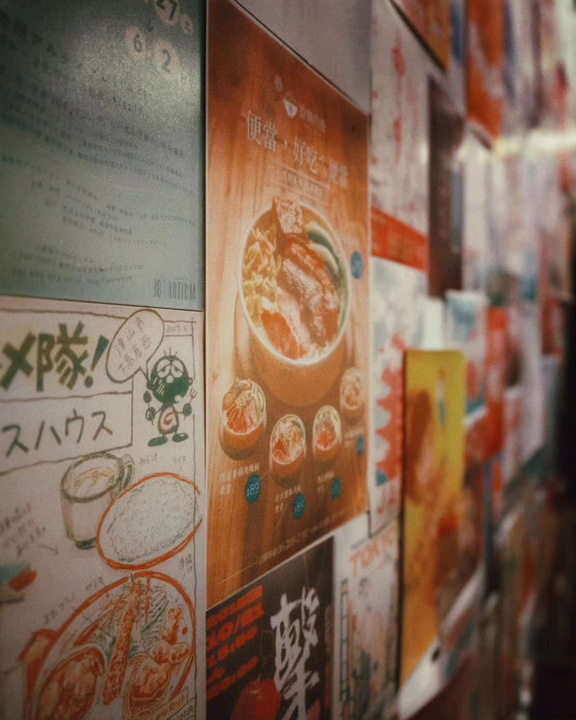 japanese posters on the wall of a restaurant